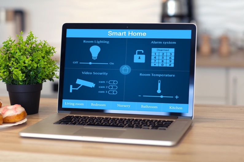 laptop with smart home on the screen is on the table in the room